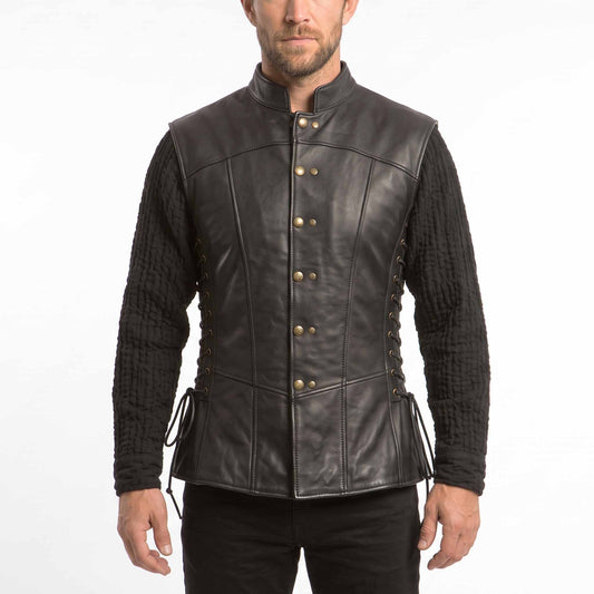 Front view of a man wearing a black real cowhide leather jerkin vest with antique brass buttons and lace-up sides over a black medieval tunic.