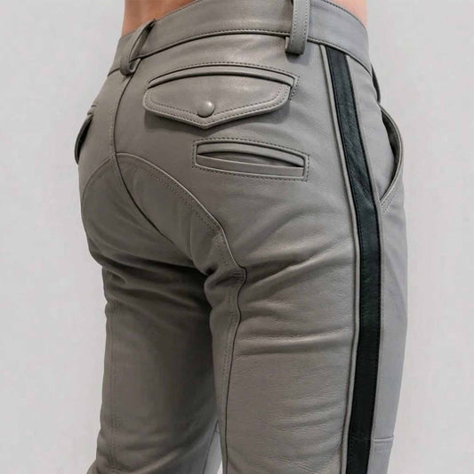 Close-up rear view of a man wearing gray cowhide leather breeches with a crisp black side stripe, featuring buttoned rear flap pockets and custom paneling.