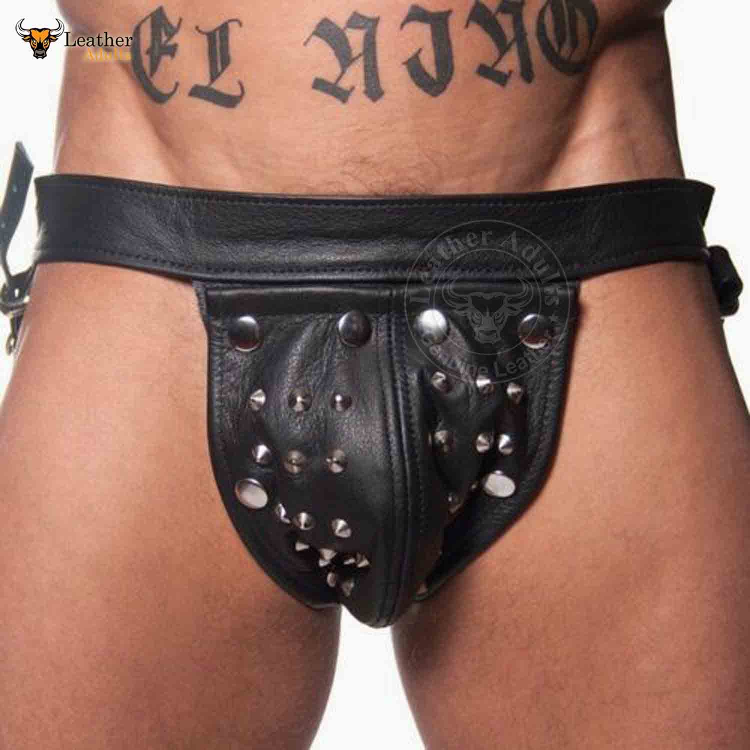 This image features a men's fetish underwear designed with a rugged, edgy aesthetic. The underwear is crafted from genuine cowhide leather and includes a distinct cod-piece jockstrap design.
