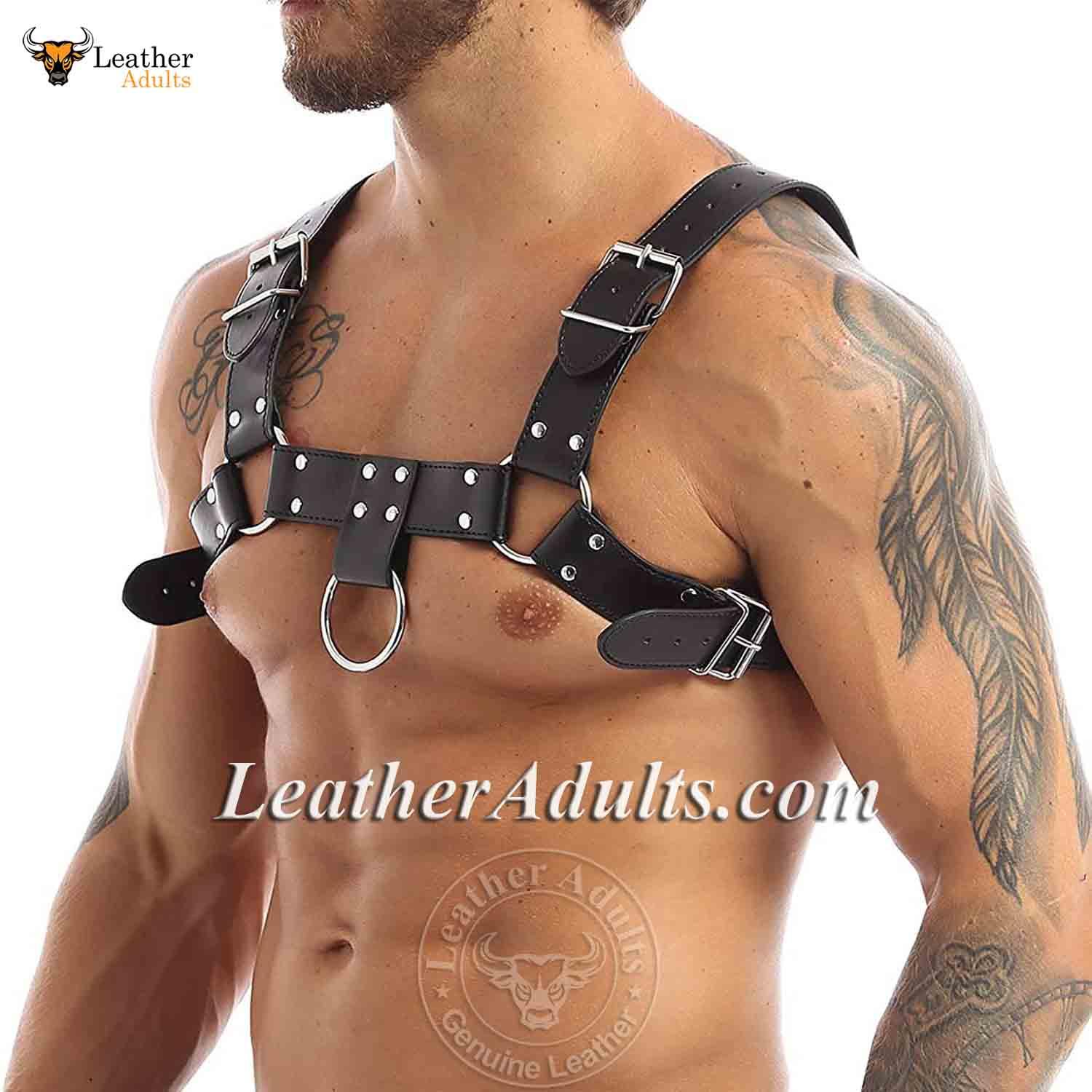 Man wearing a black leather harness with visible tattoos on a white background, featuring the brand 'KSK Leather'.