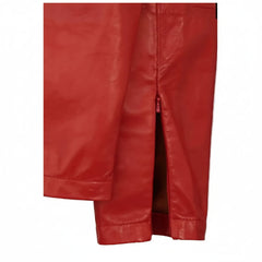 A close-up of a red leather garment, likely a jacket or coat, showing the texture and a side slit,.