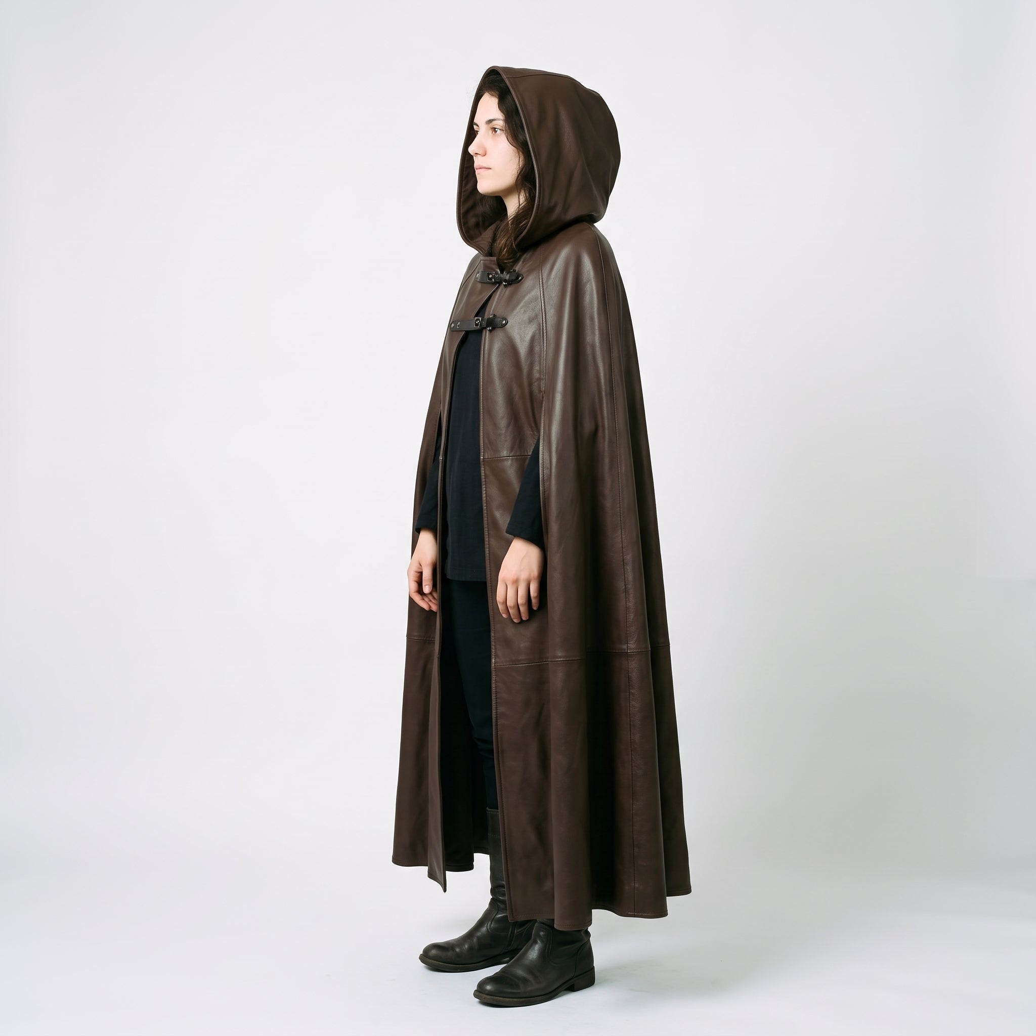 Direct side profile of woman wearing tailored brown leather fantasy ranger cloak showing full height drape and hood shape