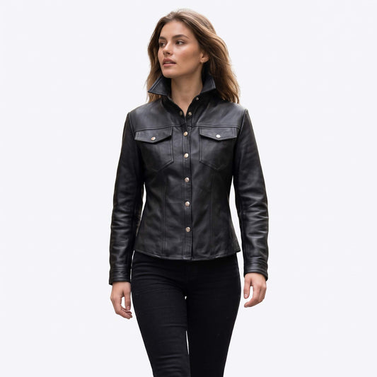 Front view of a woman wearing a tailored black leather shirt jacket with an upright stand collar, silver snap buttons, and chest pockets.