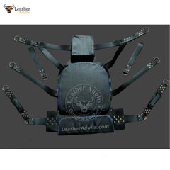 A black leather sex sling and swing with multiple straps and rivets, designed for adult use.
