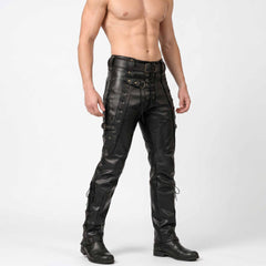 Front three quarter perspective of male model wearing slim fit black leather gothic trousers with buckle straps and boots