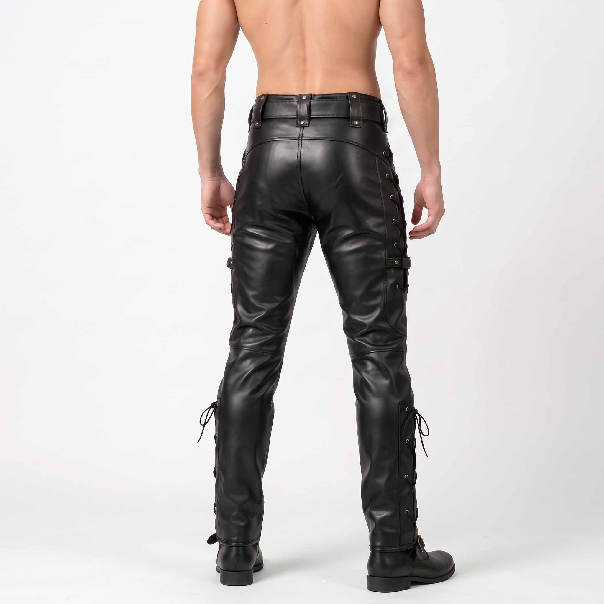 Back studio view of man wearing black genuine leather biker pants showing snap flap rear pockets and calf buckle straps