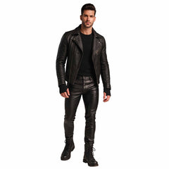 Full length studio shot of handsome man wearing black leather motorcycle jacket, black leather slim jeans, and lace up boots