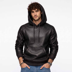 Full front shot of handsome curly haired man wearing handmade black sheepskin leather hoodie with hood up and hands in pockets