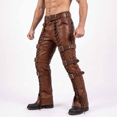 Front three quarter perspective of male model wearing brown leather steampunk warrior trousers with roller buckles and combat boots
