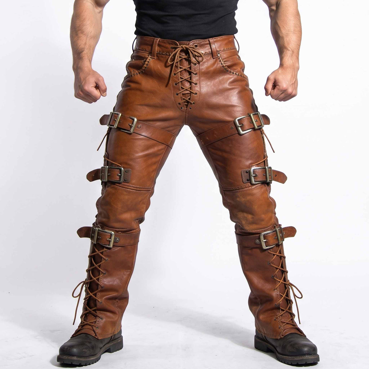 Front view of athletic man in power stance wearing handmade brown leather buckle pants with front lace up fly and roller straps
