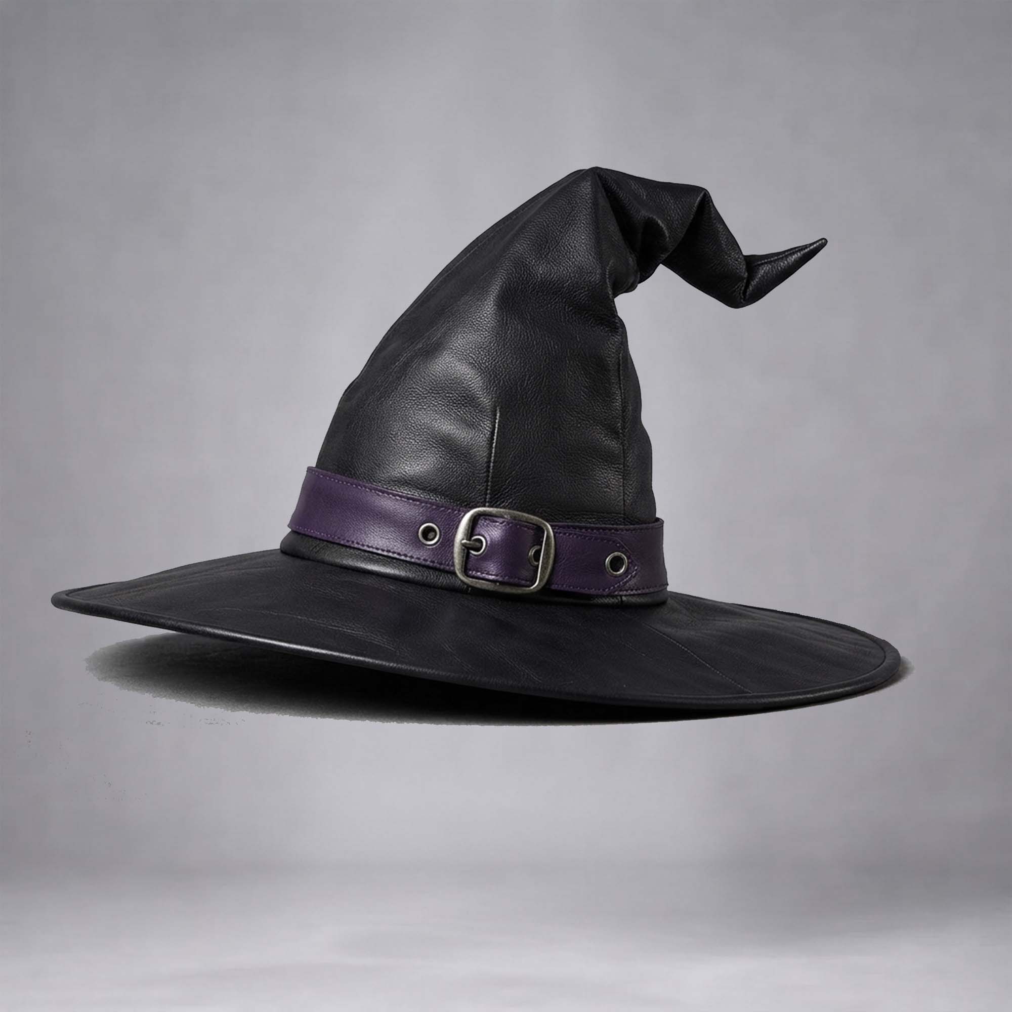 Studio shot of the handmade black leather witch hat accented with a purple band and metal buckle.