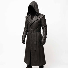 Front three quarter studio shot of hooded figure wearing handmade black cowhide leather trench coat with waist belt and wide lapels