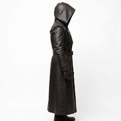 Left side view of black genuine cowhide leather duster coat showing straight vertical silhouette, belted waist, and wrist details