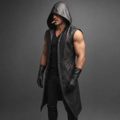 Front three quarter perspective of man wearing long black leather gothic vest open over dark v neck tee on grey studio background