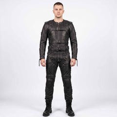 Full length front view of athletic man wearing handmade black cowhide leather restraint suit with front buckle straps, padded knees, and combat boots