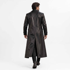 Back full length studio view of mens black leather duster coat showing tailored vertical back seams and deep center split walking vent