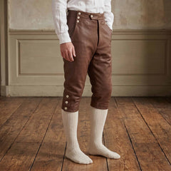 Side profile angle of men brown cowhide leather colonial knee breeches showing buttoned knee cuffs and high fall front waistband