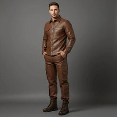 Model posing with hands in pockets showcasing the tailored chest flap pockets and side utility cargo pockets on the men's brown leather set