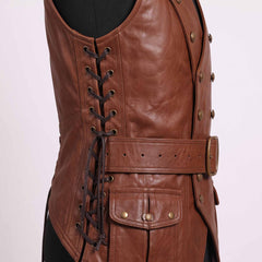Close up side view of brown leather vest detailing brass side lacing grommets, leather ties, roller buckle belt, and cargo hip pocket