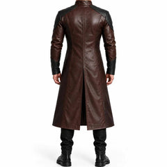 Back view of man wearing two tone brown leather duster coat showing black shoulder yoke and deep center split walking vent
