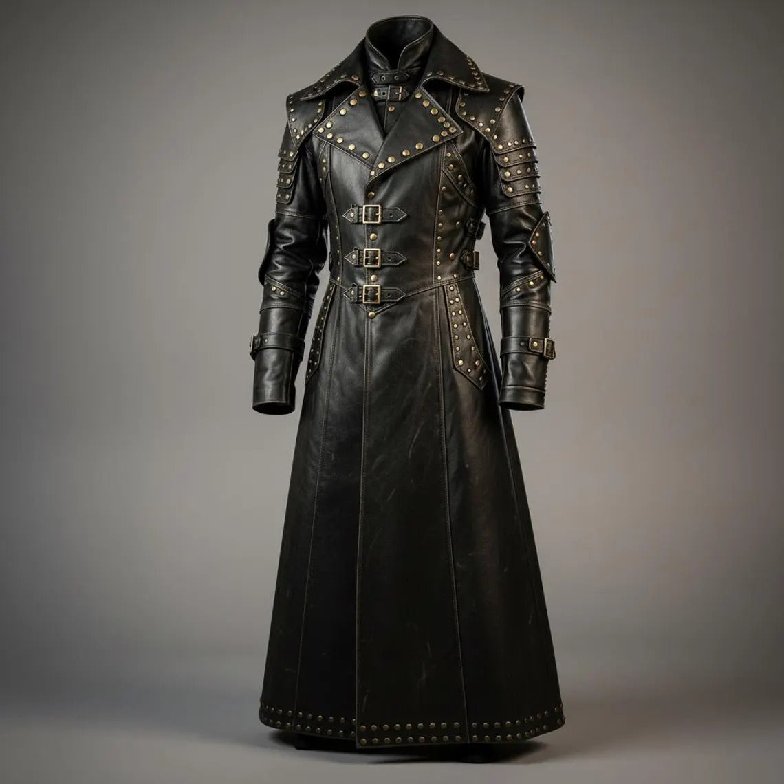 Full length front view of handmade black leather gothic trench coat featuring antique brass studs, triple front buckle closures, and armor pauldrons