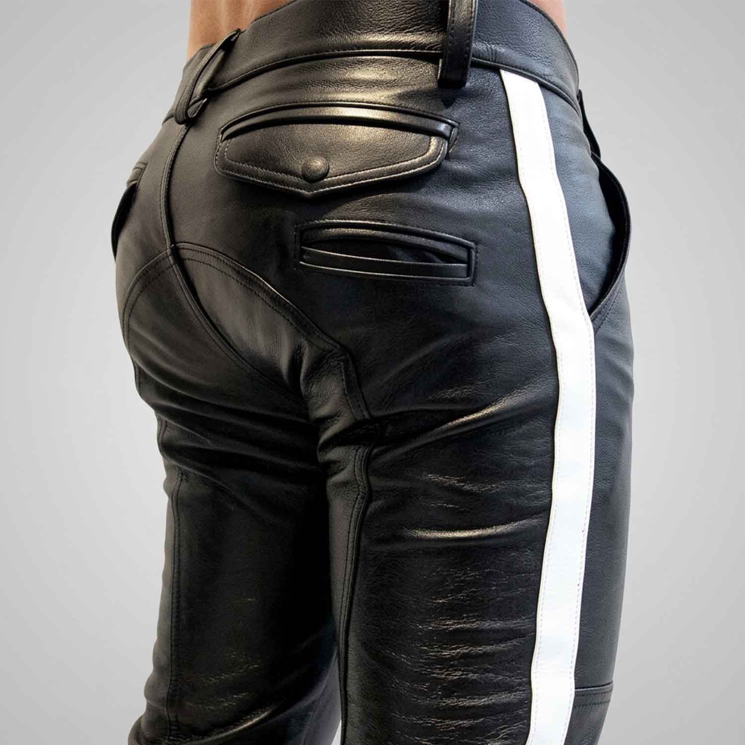 Close-up rear view of a man wearing black cowhide leather breeches with a crisp white side stripe, featuring buttoned rear flap pockets and custom paneling.