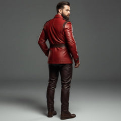 Rear three quarter view of mens red leather tunic jacket detailing back tailoring seams shoulder strap trims and brown leather pants