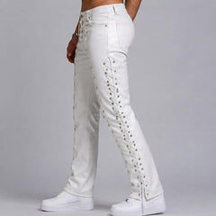 Side profile view showcasing the silver eyelets and full-length crisscross lace-up detail along the outer seam of men's white leather biker pants.