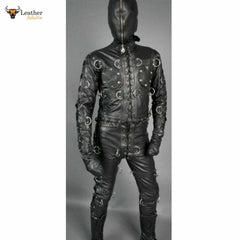 A person wearing a black leather bondage suit with D-rings, designed for full coverage and Restraint play. The suit includes a hood and is fully zipper for adjustments.