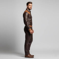 Side profile view highlighting the slim-straight cut and shoulder yolk detailing of the men's custom brown leather two-piece outfit