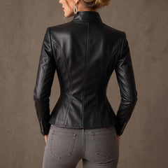 Back view of female model wearing black genuine leather blazer displaying contoured spine seams and flared peplum skirt hem