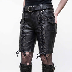 Close-up front view of handmade black leather knee-length shorts highlighting silver eyelet corset thigh lacing, studded pockets, and waist belt