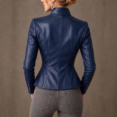 Back view of woman wearing fitted navy blue leather blazer showing contoured spine princess seams, standing collar, and flared peplum hem