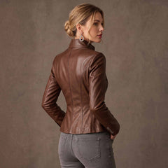 Three quarter back view of woman modeling cognac brown leather fitted blazer showing tailored spine princess seams and buttoned wrist cuffs