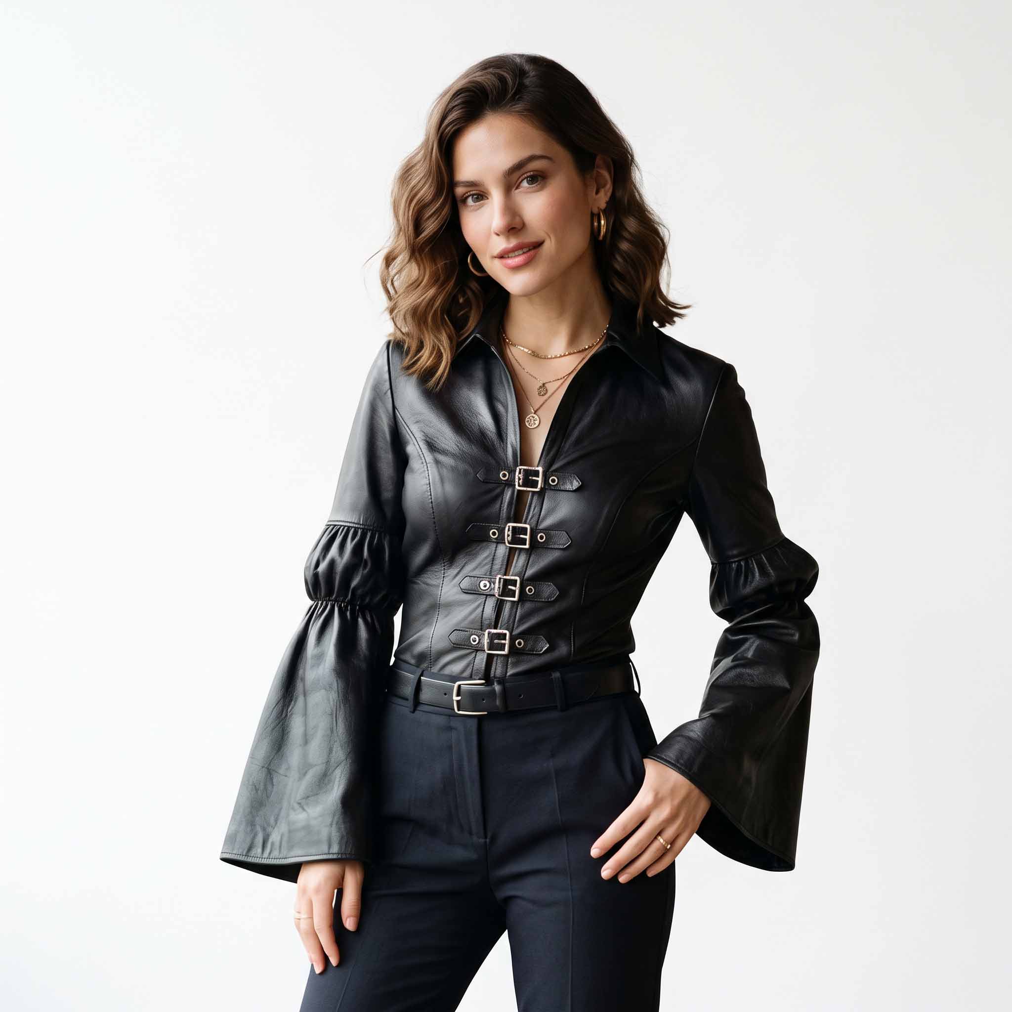 Studio portrait of woman on white background modeling handmade black genuine leather poet blouse with spread collar and front buckles