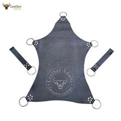 A black leather sex swing sling with attached leather stirrups and metal D-rings, featuring the brand logo 'KSK Leather' and the word 'Genuine Leather' embossed on it.