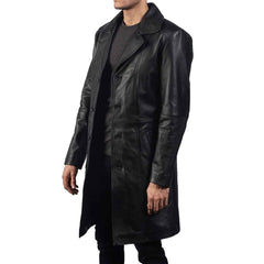 Three-quarter side angle of a men's real black cowhide leather duster coat showing side pocket placement and button closure.